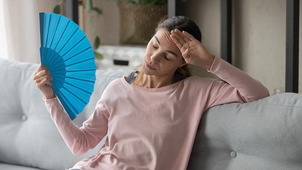 Girl feeling uncomfortable without air conditioning - heat pump troubleshooting