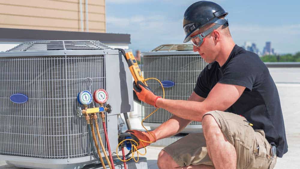 Man checking refrigerant of HVAC system. 