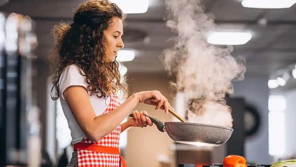 Girl cooking in the kitchen.