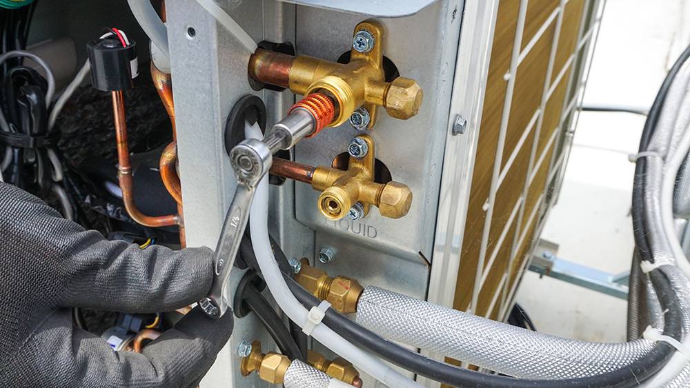 HVAC professional checking refrigerant levels