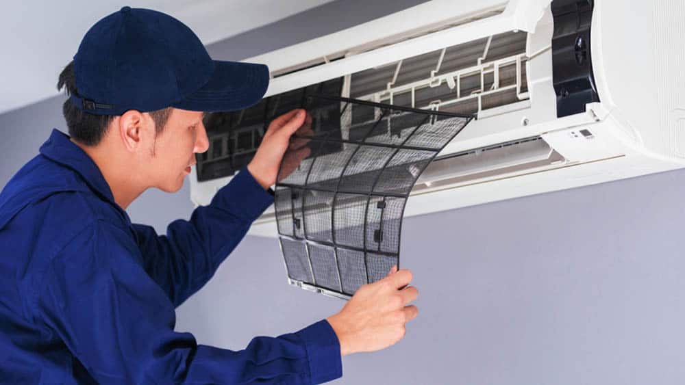 Technician replacing filter of Air conditioner. 
