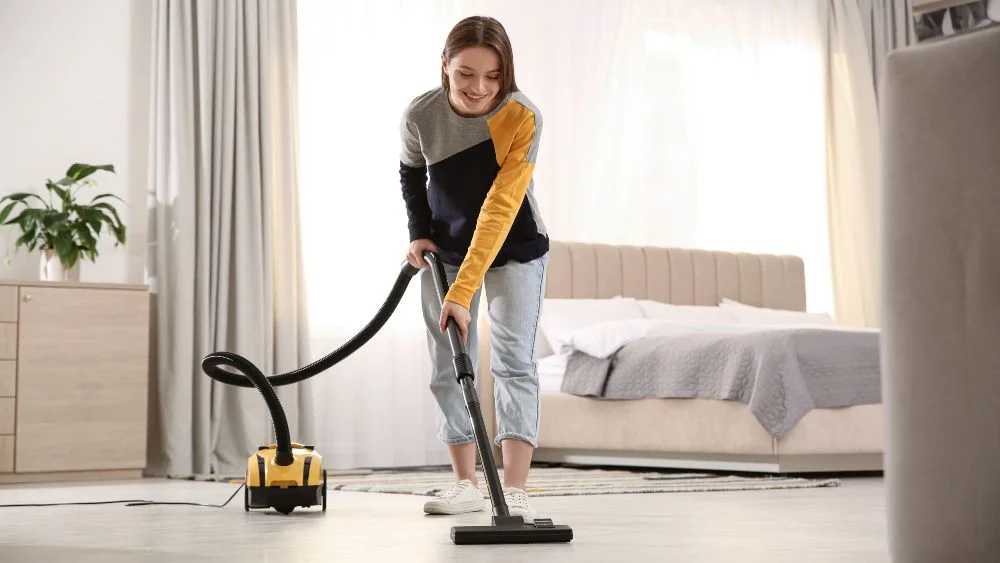 a woman vacuuming her home