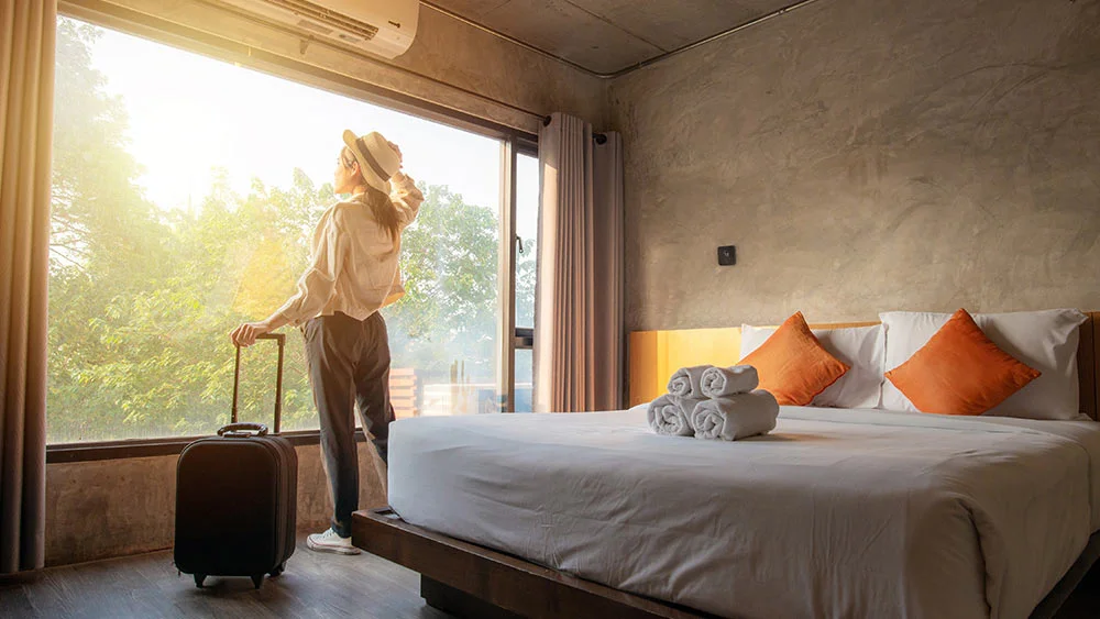 woman standing in vacation rental with cielo breez max on wall