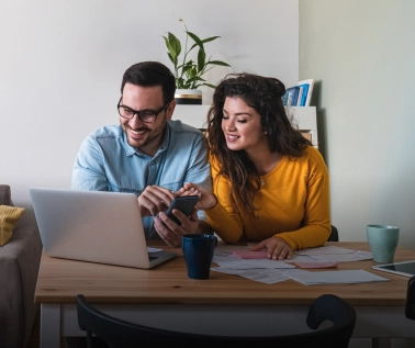 A couple checking their bills online