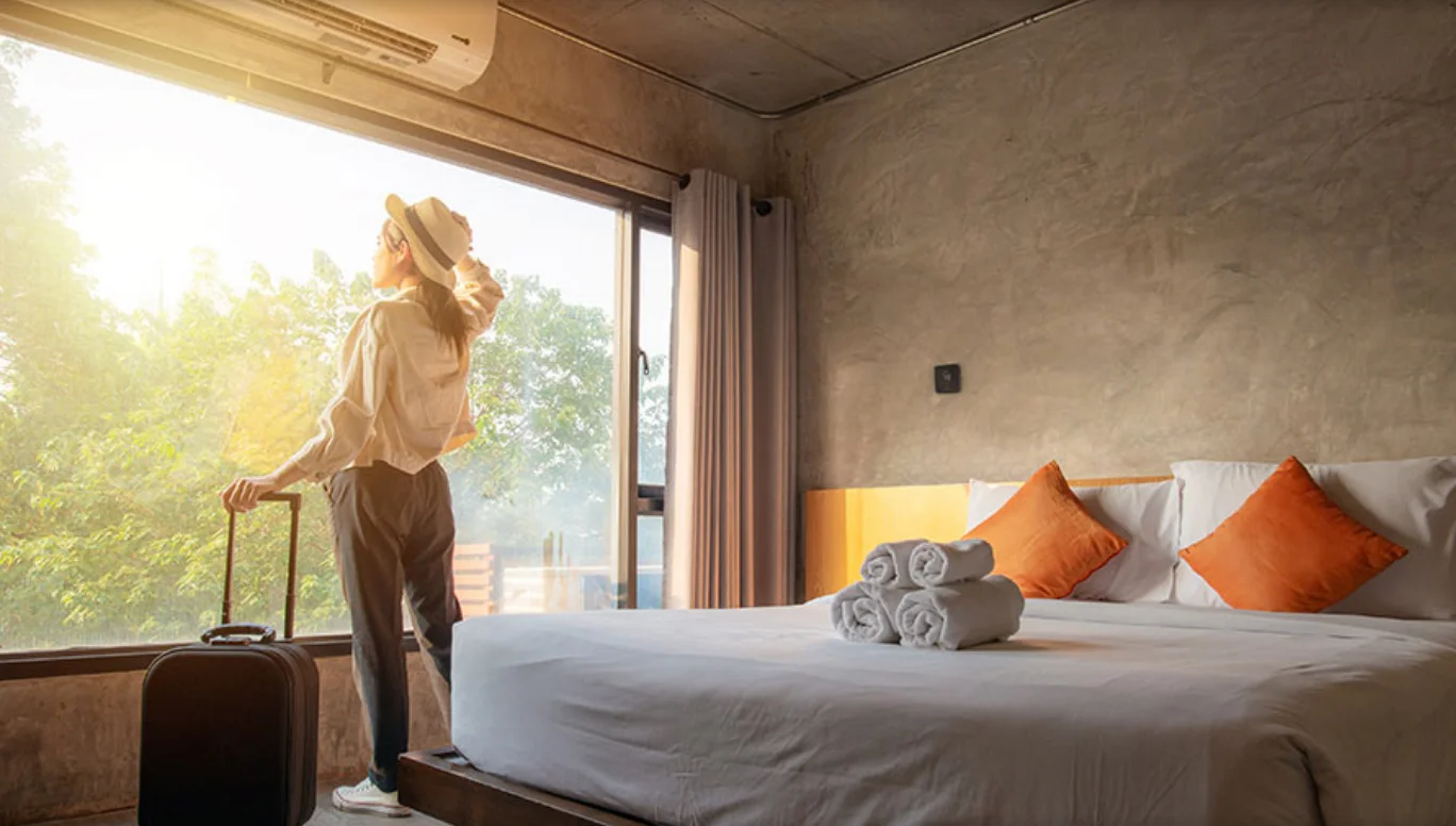 woman standing in vacation rental with max on wall