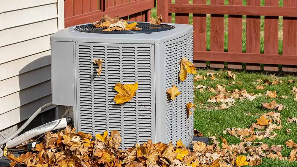 air conditioner outdoor unit being cleaned