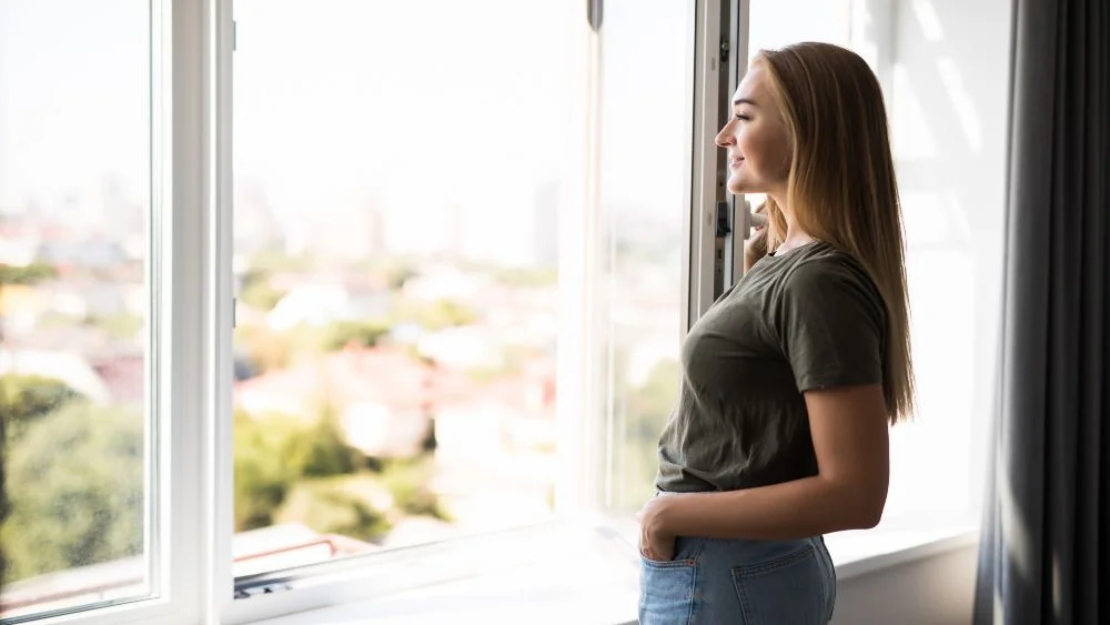 a woman looking outside the window