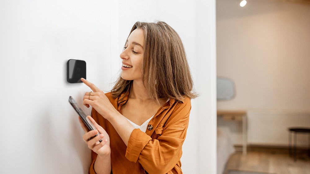 A girl using smart thermostat