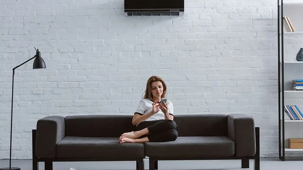 Girl using her phone on the sofa.
