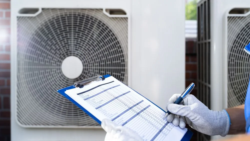 Technician going through an HVAC inspection checklist