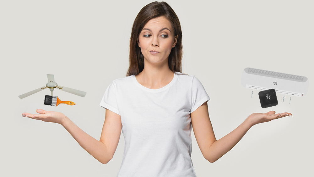 A person trying to decide among different garage cooling options like AC or fan