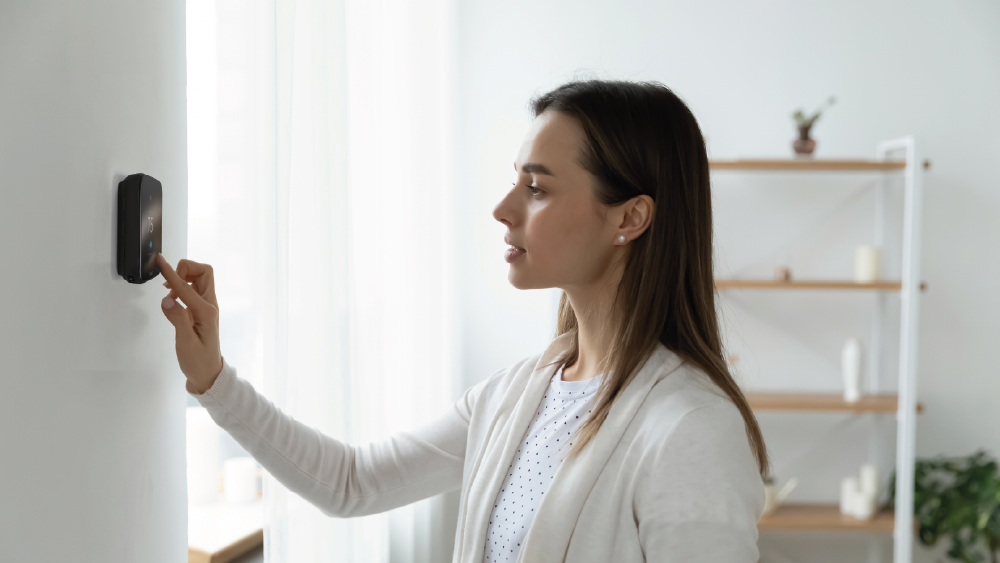 Woman making changing on her Cielo smart thermostat