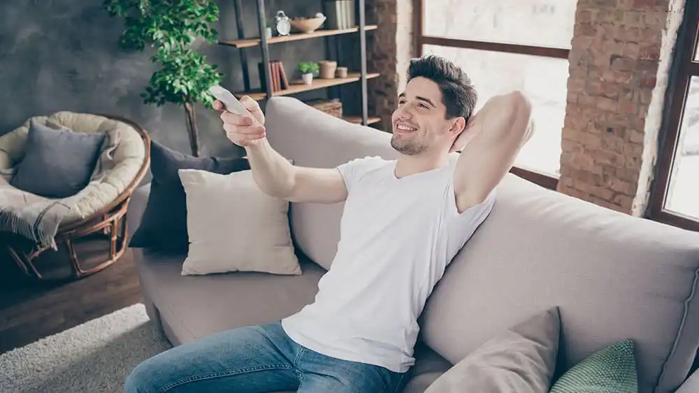 Man using AC remote.