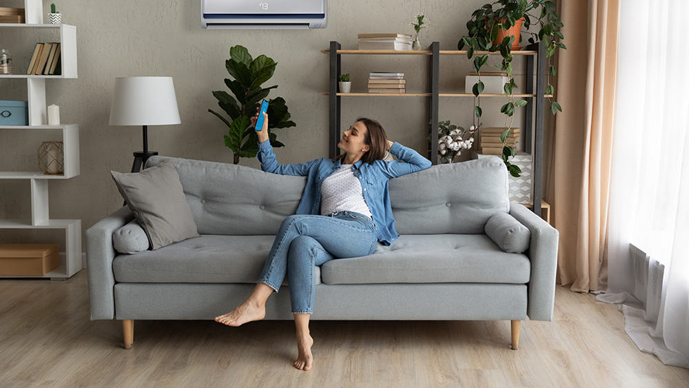 Girl turning on the AC using her phone.