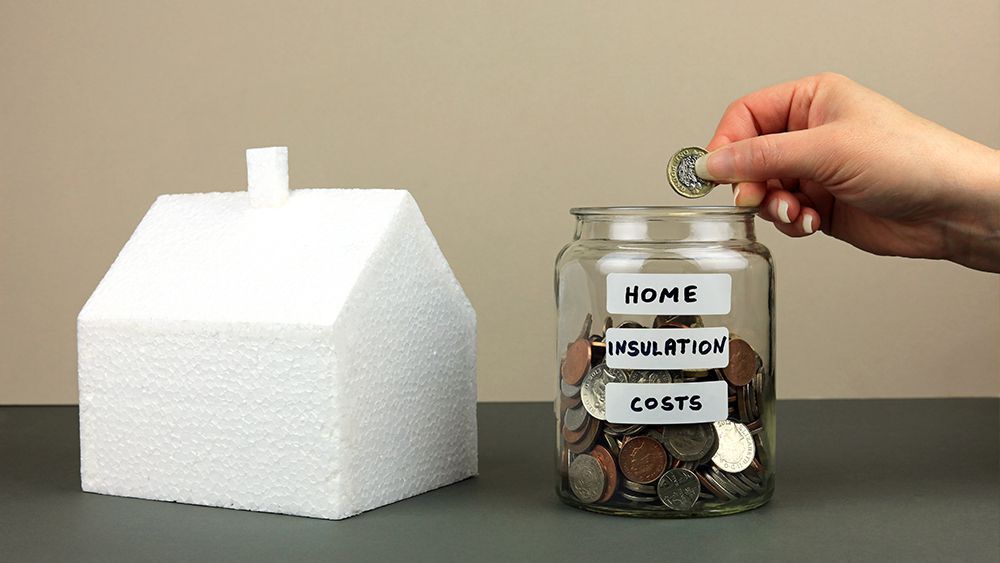 A jar full of coins wit a label, 'home insualtion cost'