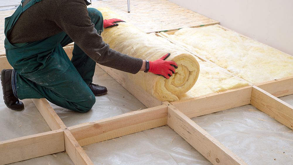 A man is insulating the floor