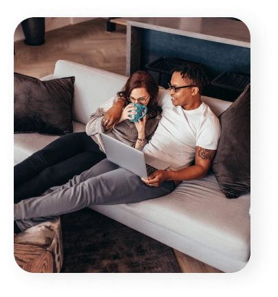 A man working while a woman drinks coffee